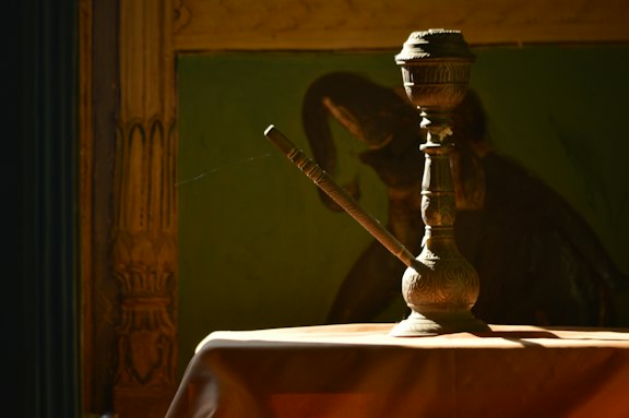 brass-colored teapot on table